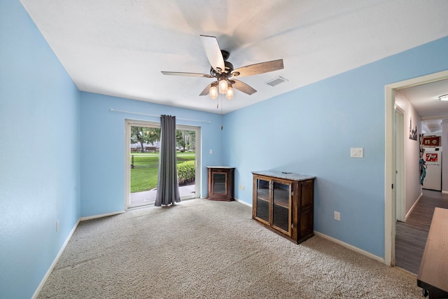 spare room featuring carpet and ceiling fan