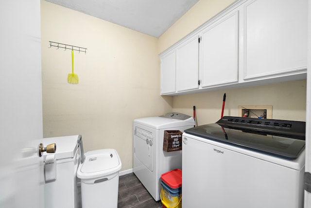 washroom featuring cabinets, washer and dryer, and dark hardwood / wood-style floors