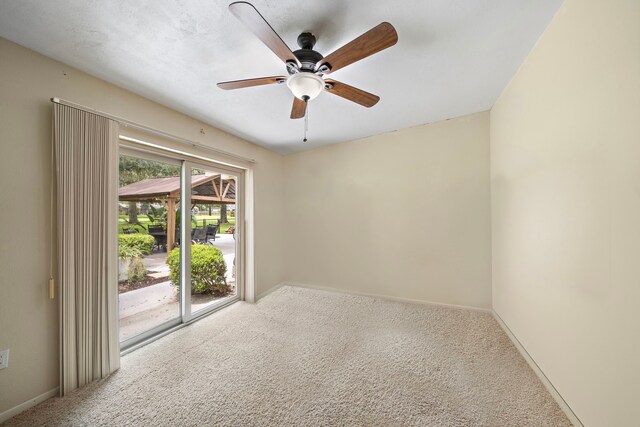 carpeted empty room featuring ceiling fan