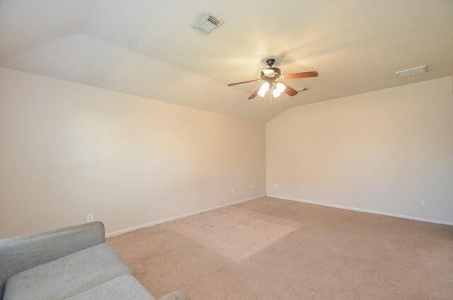 interior space featuring baseboards, visible vents, and vaulted ceiling