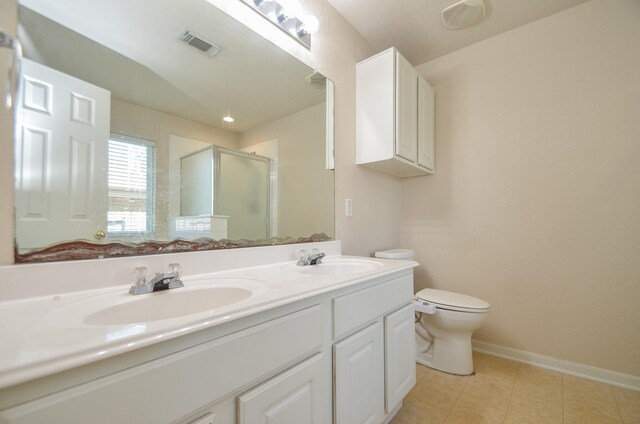 full bathroom featuring toilet, a shower stall, visible vents, and a sink