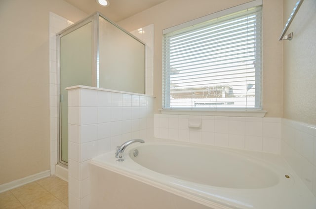 full bath featuring a stall shower, tile patterned flooring, and a bath