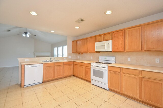 kitchen with light countertops, white appliances, a sink, and visible vents