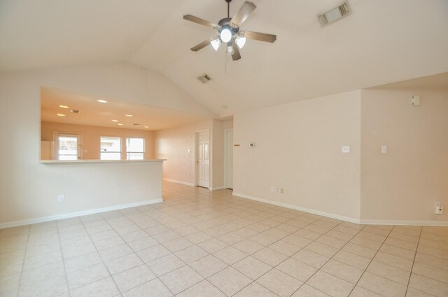 unfurnished room with visible vents, vaulted ceiling, baseboards, and ceiling fan