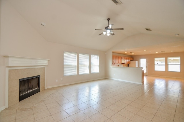 unfurnished living room featuring a fireplace, light tile patterned floors, visible vents, a ceiling fan, and baseboards