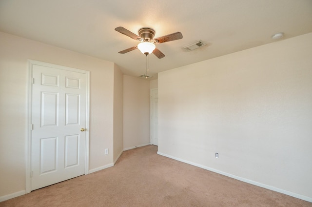 unfurnished bedroom with light colored carpet, visible vents, and baseboards