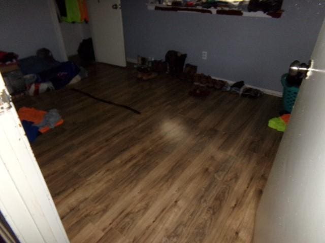 bedroom with dark wood-type flooring