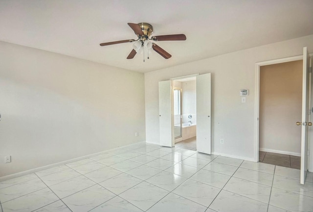 empty room with a ceiling fan, baseboards, and light tile patterned floors