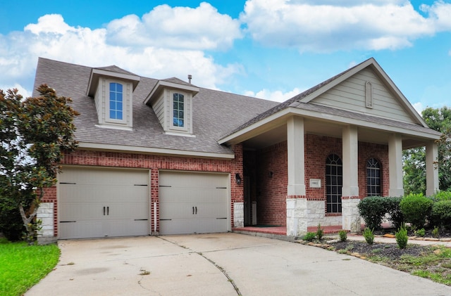 view of front of house with covered porch and a garage