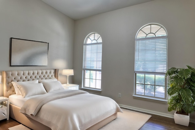 bedroom featuring dark hardwood / wood-style floors and multiple windows