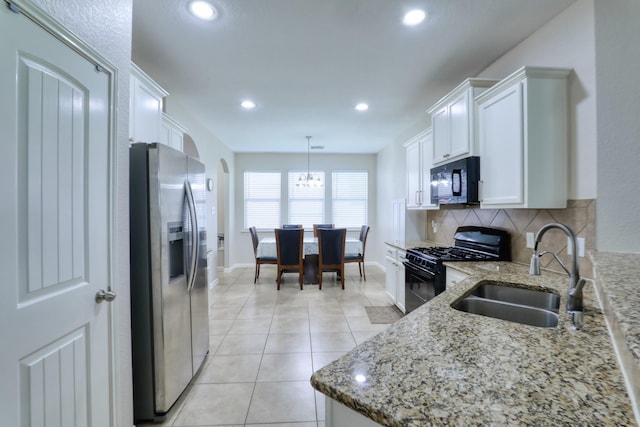 kitchen with white cabinetry, sink, tasteful backsplash, decorative light fixtures, and black appliances