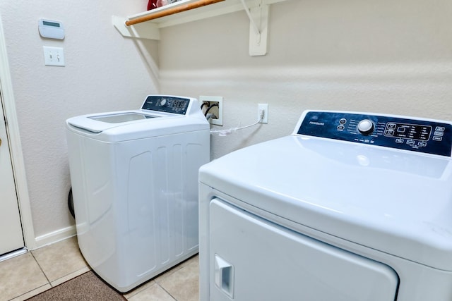 laundry room featuring light tile patterned flooring and washer and dryer