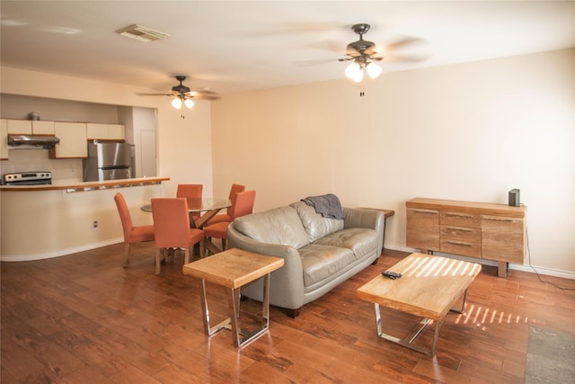 living room featuring wood-type flooring and ceiling fan