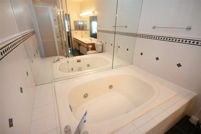 bathroom with shower with separate bathtub, vanity, and tile patterned floors