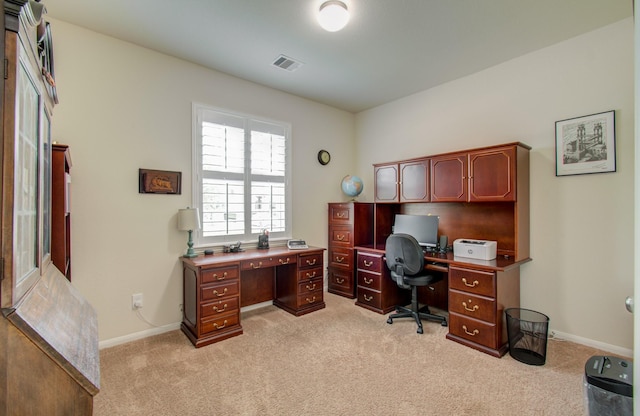 office area featuring baseboards, light colored carpet, and visible vents