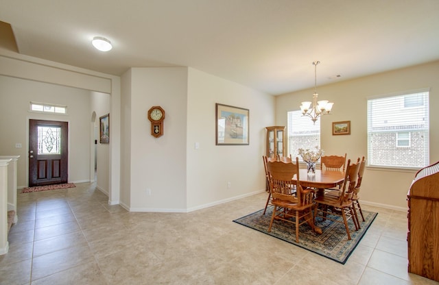 dining room with baseboards, a chandelier, and light tile patterned floors