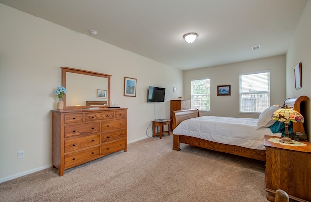 bedroom featuring light colored carpet, baseboards, and visible vents