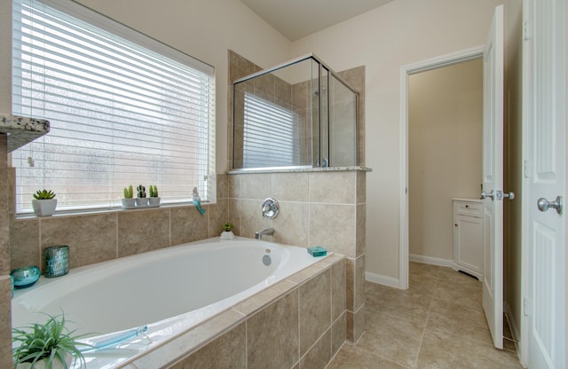 full bathroom featuring baseboards, tile patterned flooring, a stall shower, and a bath