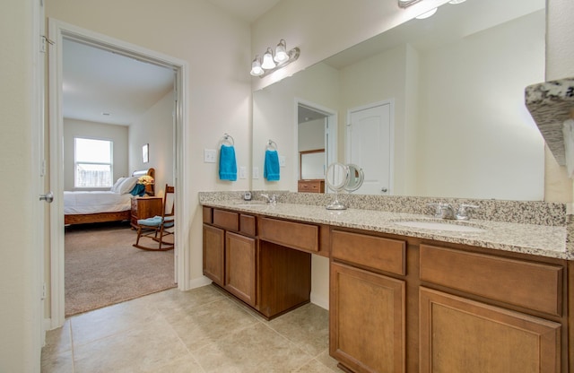 ensuite bathroom featuring double vanity, a sink, ensuite bath, and tile patterned flooring