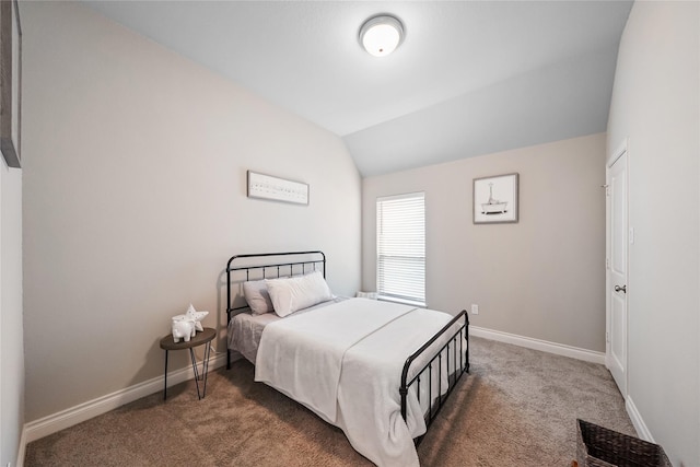 carpeted bedroom with lofted ceiling