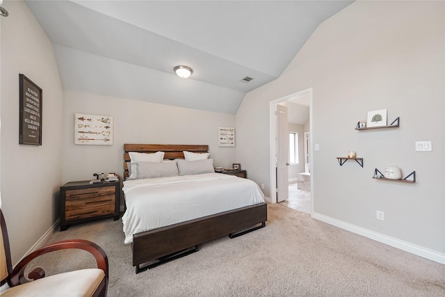 carpeted bedroom with vaulted ceiling