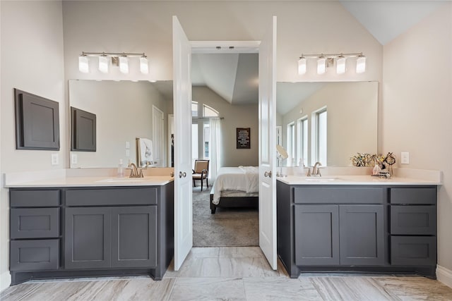 bathroom featuring lofted ceiling and vanity