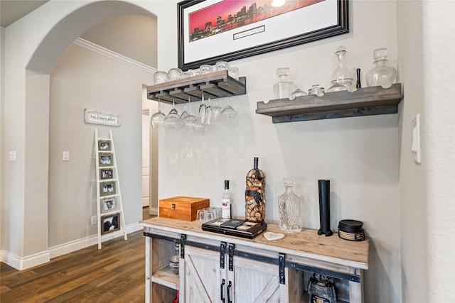 bar with dark hardwood / wood-style flooring and crown molding