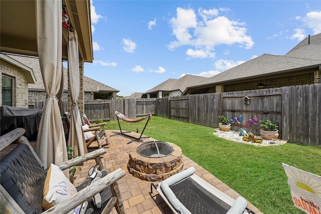 view of yard featuring a patio and a fire pit