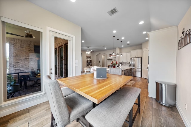 dining room with ceiling fan and sink