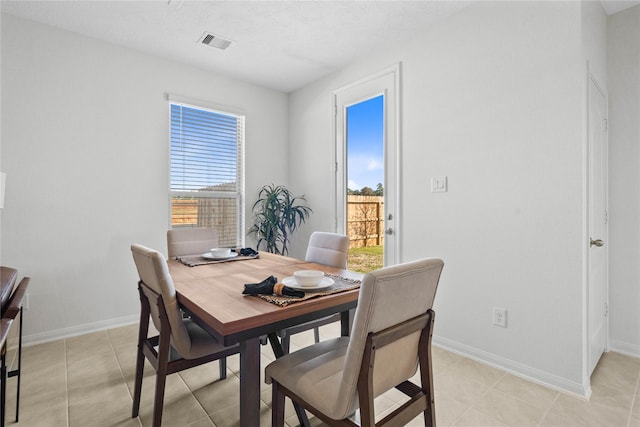 dining room with light tile patterned floors and a textured ceiling