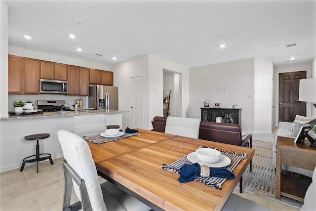 dining space featuring light tile patterned floors