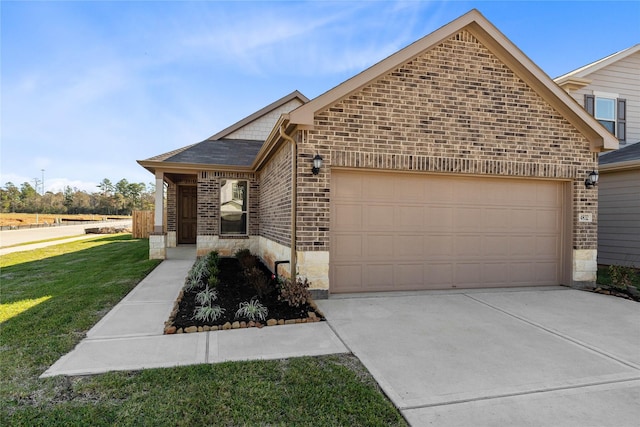 view of front of property featuring a garage and a front lawn