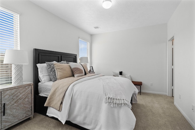 bedroom featuring carpet and a textured ceiling