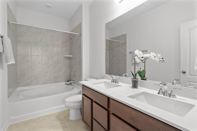 full bathroom with toilet, vanity, tile patterned floors, and tiled shower / bath