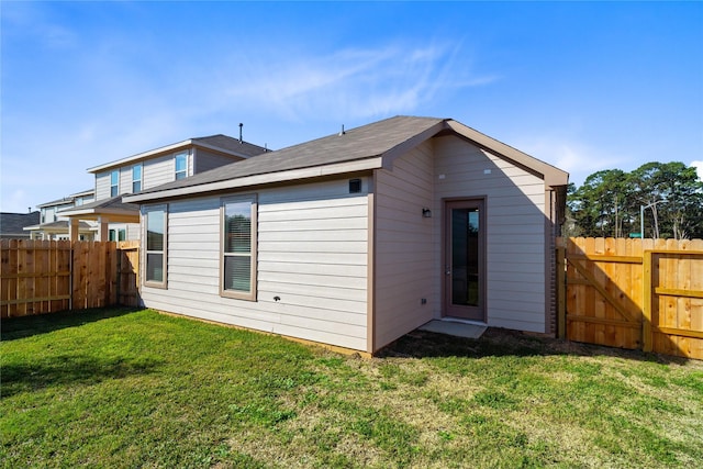 rear view of property with a yard