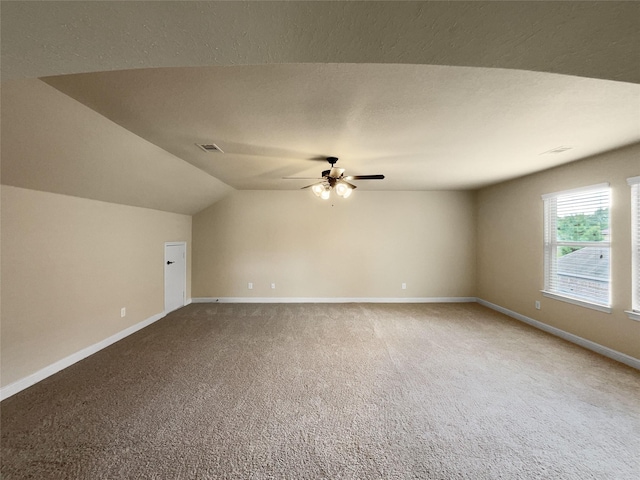 interior space with ceiling fan, carpet flooring, and lofted ceiling