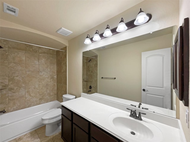 full bathroom with toilet, tiled shower / bath, tile patterned floors, and vanity