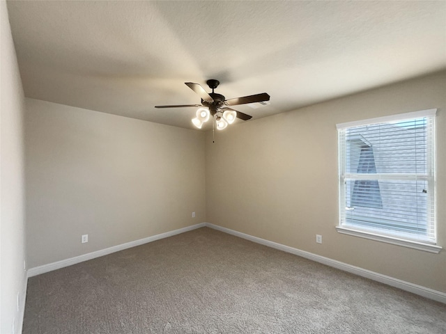 carpeted empty room featuring ceiling fan