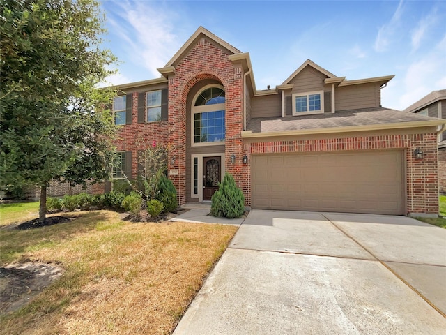 view of front of home featuring a front yard and a garage