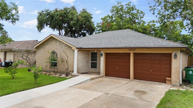 ranch-style home featuring a garage and a front lawn