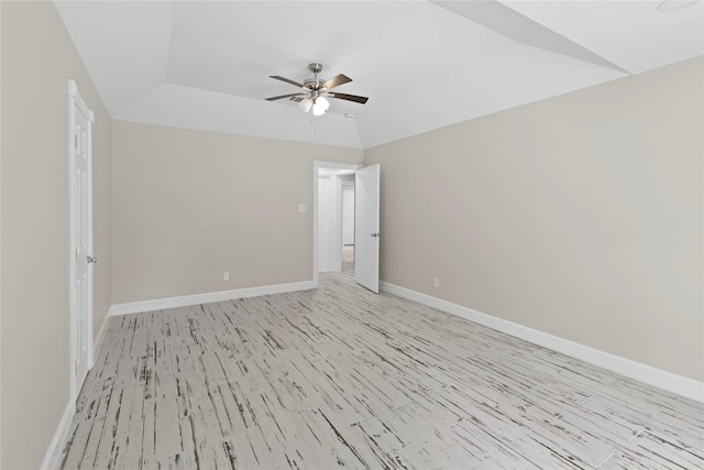 empty room with ceiling fan, light hardwood / wood-style floors, and lofted ceiling