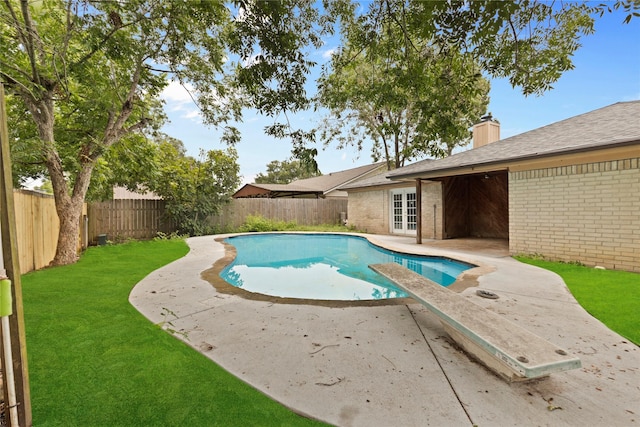 view of swimming pool with a yard, french doors, and a patio