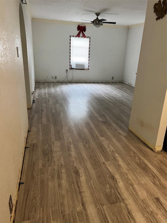 empty room featuring ceiling fan and hardwood / wood-style floors