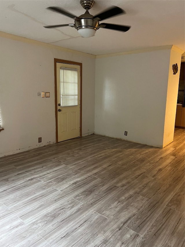 empty room featuring light wood-type flooring, ceiling fan, and ornamental molding