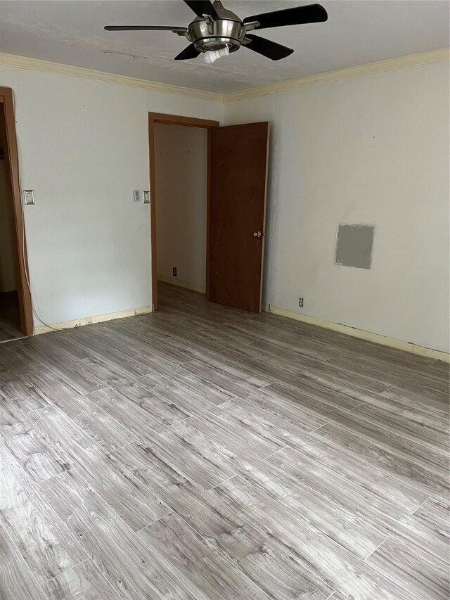 empty room with light hardwood / wood-style flooring, ceiling fan, and crown molding