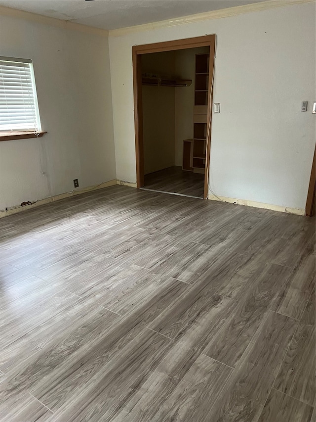 unfurnished bedroom with a closet and wood-type flooring