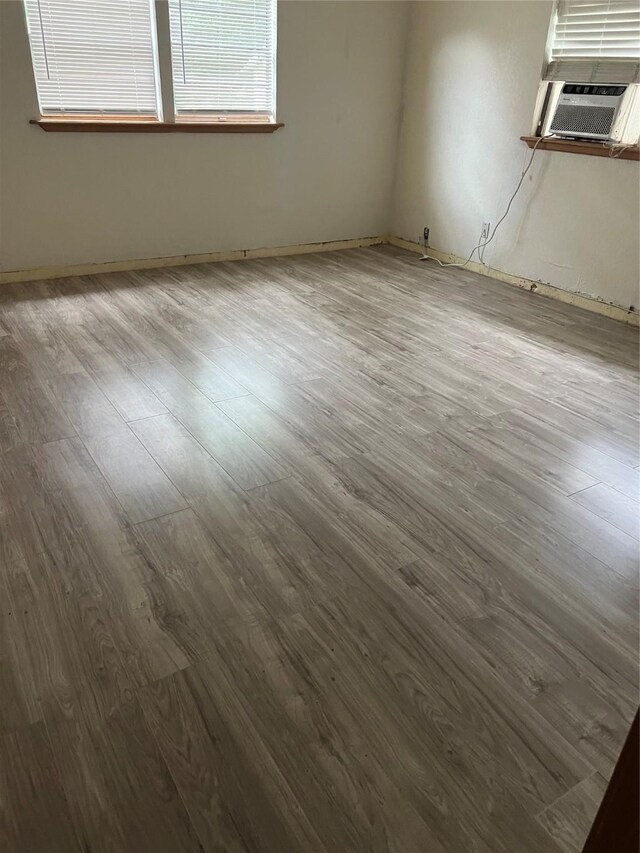 empty room with hardwood / wood-style flooring and cooling unit