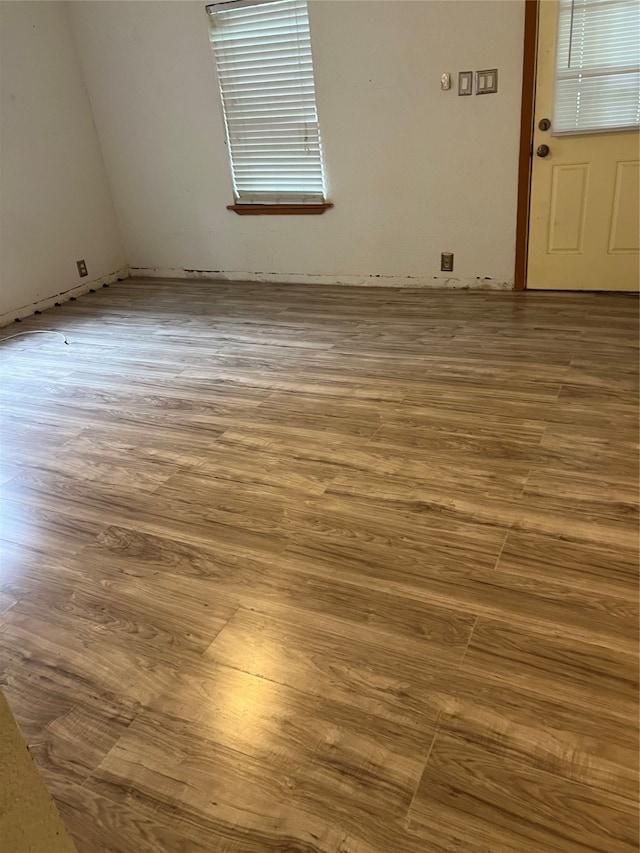 unfurnished room with hardwood / wood-style floors