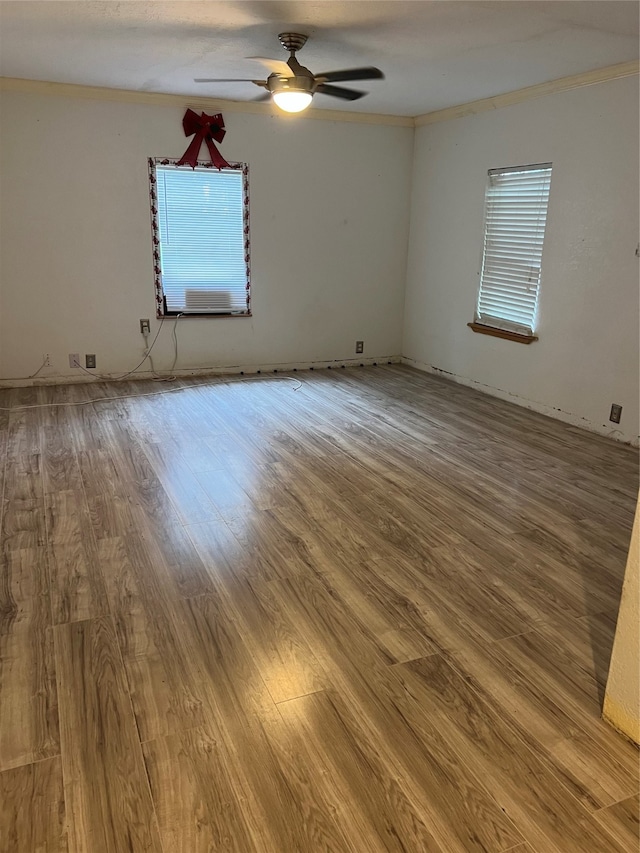 unfurnished room featuring ornamental molding, ceiling fan, and hardwood / wood-style floors