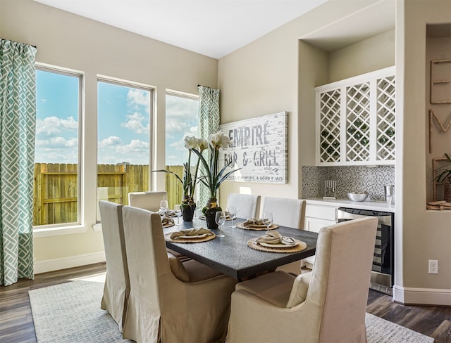 dining area featuring beverage cooler and dark hardwood / wood-style floors